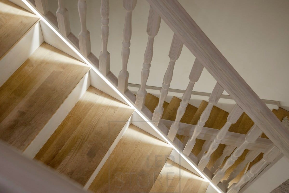 Led strip milled at the bottom of the stair handrail, as close as possible to the steps.